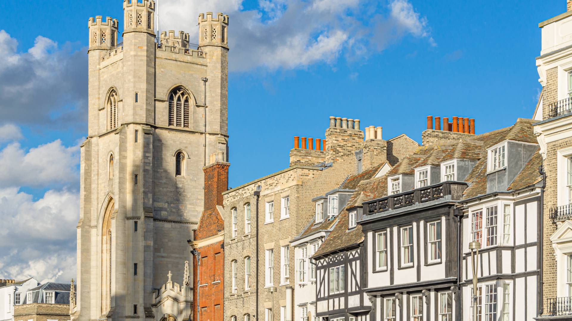 Cambridge Eightfold Historic church tower and shops in Cambridge city centre