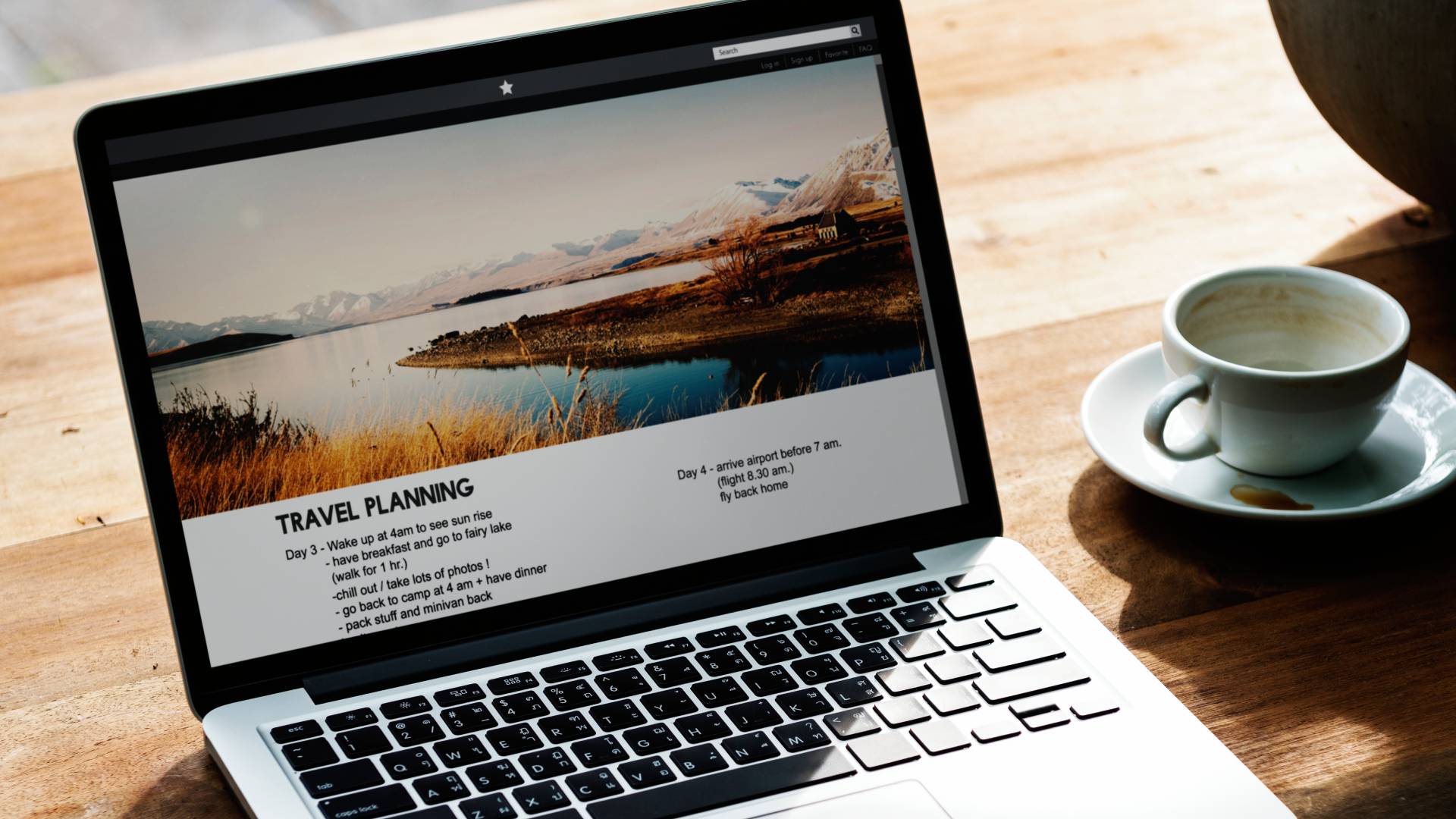 Laptop showing a website on a desk with a cup of coffee